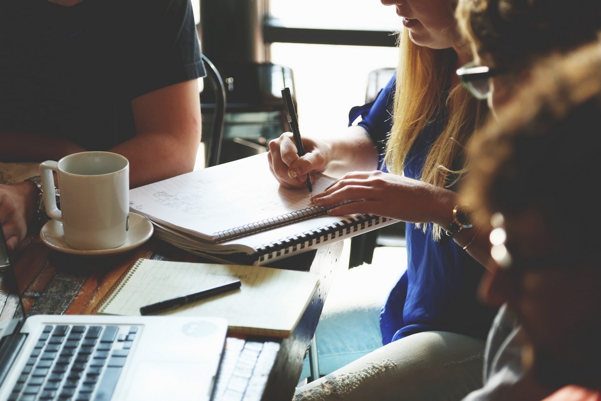 Woman taking notes in meeting