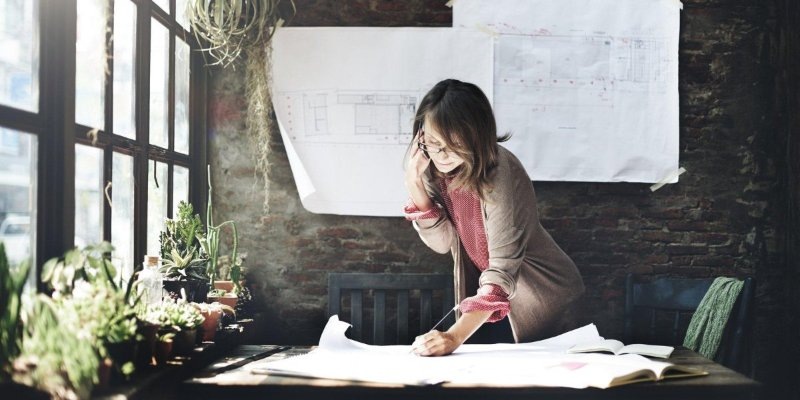 Woman working in office while on the phone