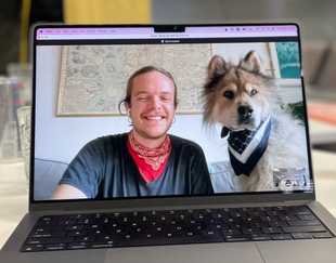 Photo of a Toggl employee with his dog on Zoom call
